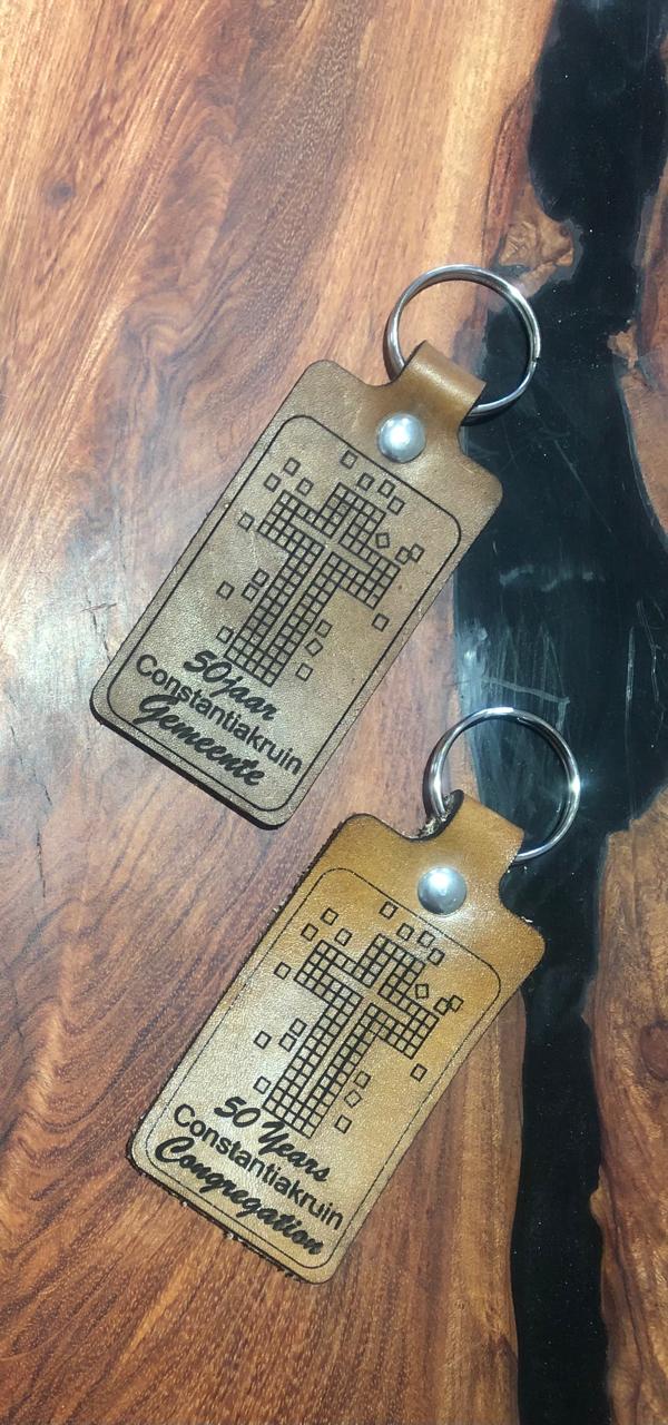 Custom laser-engraved premium leather keyring with personalized initials and a high-quality metal attachment.